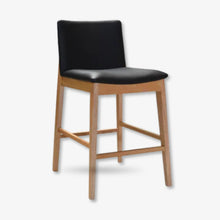 Bonny bar stool upholstered in black leather with solid timber legs