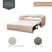 Eric sofa bed shown fully extended in oyster fabric with back cushions and fabric swatches, available to view in store.