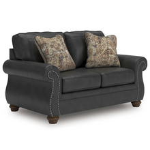 Angled view of Ashley Shadsburne 2 Seater Sofa showing rolled arms, turned timber-look legs and accent cushions.