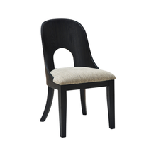 Angled view of Rowenbeck dining chair showcasing sculpted back and beige upholstered seat – Ashley Furniture at Caesars Griffith