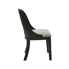 Side profile of Rowenbeck dining chair highlighting sleek curved design and sturdy timber legs