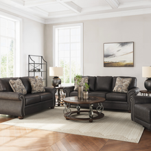 Shadsburne 3 seater sofa in Earth Granite faux leather shown with matching loveseat and recliner in living room setting.