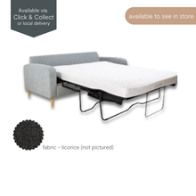 Angled view of the Frankie Sofa Bed with reversible chaise, upholstered in grey fabric with cushioned seating and clean lines.