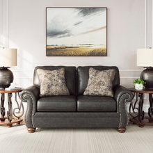 Detail shot of Ashley Shadsburne 2 Seater Sofa showing antique brass nailhead trim and plush accent cushions in Earth Granite finish.