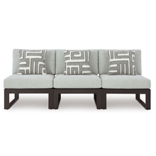 Straight-on view of three-seat modular outdoor sofa with patterned cushions