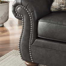 Close-up of nailhead trim and soft-touch leather-look finish on Shadsburne sofa arm.