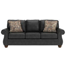Front view of Shadsburne 3 seater sofa – rolled arms with brass nailhead trim and turned timber legs.