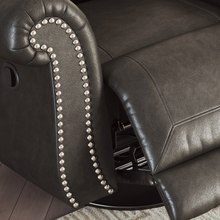 Close-up of nailhead trim and top stitching on Shadsburne recliner arm.